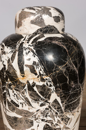 A pair of large black and white 'Grand Antique' marble vases and covers on red marble stands, Italy, 20th C.