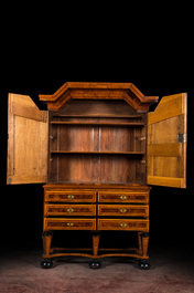 A German baroque mahogany- and root wood veneer star-cabinet on ebonised feet, 18th C.