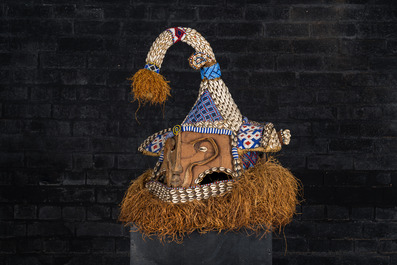 A Kuba helmet mask (mukenga) with cowrie shells, Congo, 20th C.