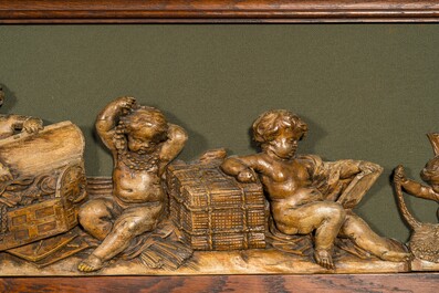 An exceptionally long carved wooden frieze with allegorical depictions of putti, 18th C.