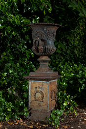 A pair of French cast iron garden vases on stands, 20th C.