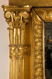 An impressive French Empire-style gilt wooden mirror on faux marble-painted stand, 19th C