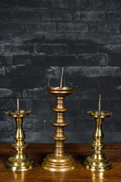 A bronze knob candlestick and a pair of baluster candlesticks, Flanders, 15/16th C. and later