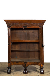 An oak wooden partly ebonised two-door cupboard on black glazed terracotta feet, Holland, 17th C. and later