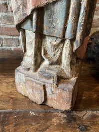 A Flemish carved and polychromed oak figure of a bishop on an armorial base, ca. 1500