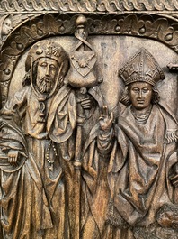 A carved oak panel depicting Saint James with a bishop, The Low Countries, late 15th C.