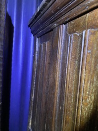 A Flemish oak three-door cupboard with carved panels, 16th C.