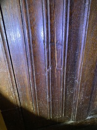 A Flemish oak three-door cupboard with carved panels, 16th C.