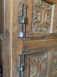 A rare large Flemish oak four-door cupboard with carved X-panels and wrought iron mounts, 1st half 16th C.