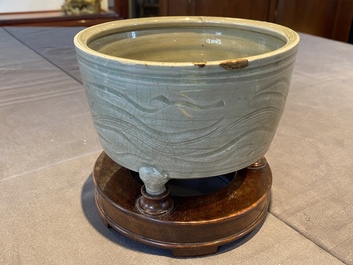 A Chinese Longquan tripod censer with kintsugi repair on wooden stand, Ming