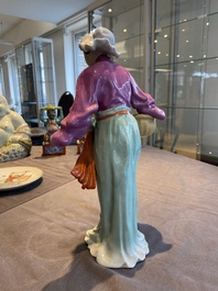 A Chinese porcelain Cultural Revolution figure of a lady with a laundry basket