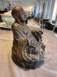 A Chinese gilt bronze figure of Buddha seated on a rock, Ming