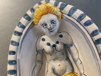 A polychrome French faience oval basin with a bathing woman, Nevers, 17th C.