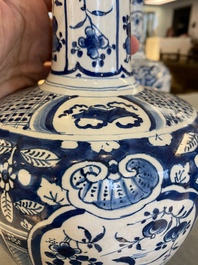 A pair of Dutch Delft blue and white chinoiserie bottle vases, 18th C.