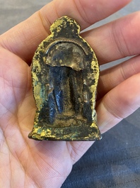 Een vergulde bronzen miniatuur Boeddha met sporen van rode lak, Tibet of Nepal, 15/16 eeuw