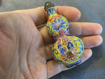 A Chinese Canton enamel snuff bottle and a pair of bone snuff bottles, 19th C.