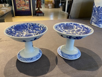 A pair of Chinese blue and white 'lotus scroll' stem cups, Kangxi