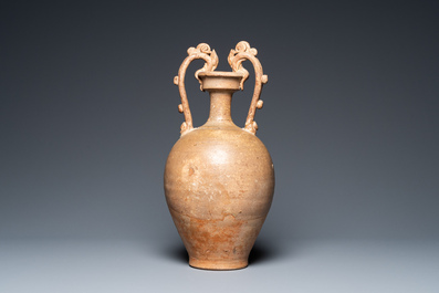 A Chinese straw-glazed stoneware amphora with dragon handles, Tang