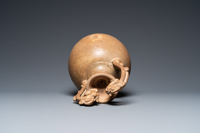 A Chinese straw-glazed stoneware amphora with dragon handles, Tang