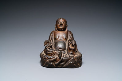 A Chinese gilt bronze figure of Buddha seated on a rock, Ming