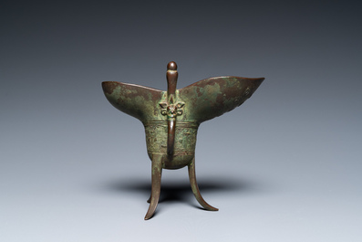 A Chinese bronze ritual wine vessel or 'jue', inscribed and dated 1701, Kangxi