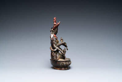 A Sino-Tibetan gilt-lacquered bronze Vasudhara, 17th C.