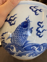 A Chinese blue and white 'dragons and carps' jardini&egrave;re on wooden stand, 19/20th C.