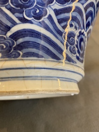 A Chinese blue and white vase with rocks in a wavy sea, Qianlong/Jiaqing