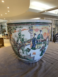 A Chinese famille verte fish bowl with female musicians in a garden, 19th C.