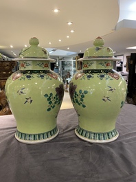 A pair of Chinese famille verte yellow-ground vases and covers, 19th C.