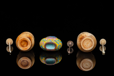 A Chinese Canton enamel snuff bottle and a pair of bone snuff bottles, 19th C.