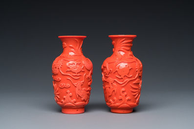 A pair of rare Chinese 'Beijing glass' vases imitating coral on wooden stands, 19/20th C.