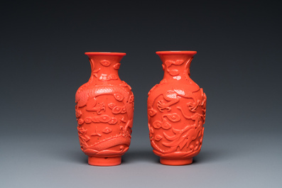 A pair of rare Chinese 'Beijing glass' vases imitating coral on wooden stands, 19/20th C.