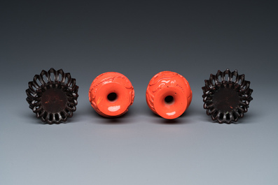 A pair of rare Chinese 'Beijing glass' vases imitating coral on wooden stands, 19/20th C.