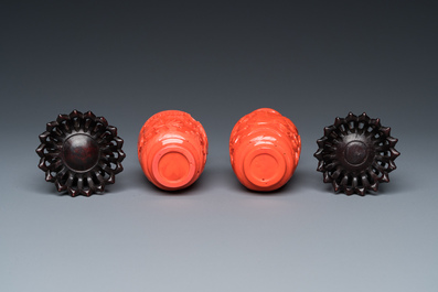 A pair of rare Chinese 'Beijing glass' vases imitating coral on wooden stands, 19/20th C.