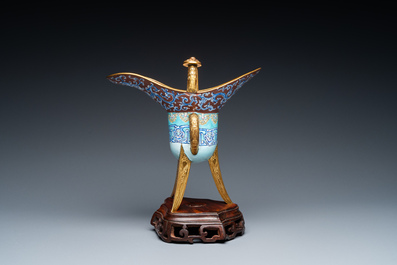 A Chinese Canton enamel and gilt bronze ritual wine vessel or 'jue' on wooden stand, 18/19th C.