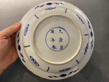 A pair of Chinese blue and white 'Mu Guiying' plates, Kangxi mark and of the period