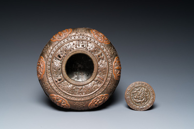 A Tibetan pierced and repouss&eacute; copper scent box and cover with inscribed mantra, 18/19th C.