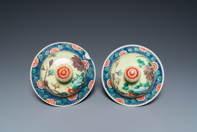 A pair of Chinese famille verte yellow-ground vases and covers, 19th C.