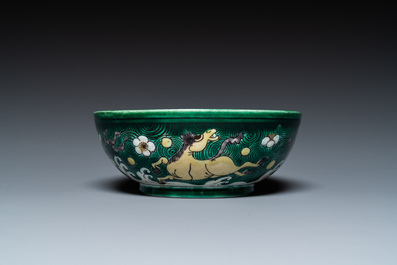 A Chinese verte biscuit 'galloping horses' bowl, Qing