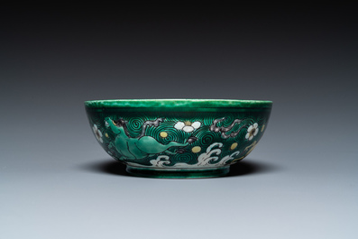 A Chinese verte biscuit 'galloping horses' bowl, Qing