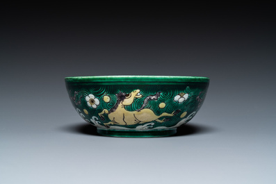 A Chinese verte biscuit 'galloping horses' bowl, Qing