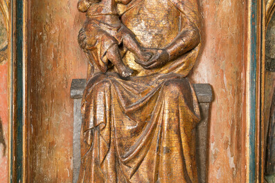 A large Spanish gilt and polychromed wooden tryptich retable with Saint John the Baptist, the Virgin Mary and Saint Roch, 1st half 16th C.