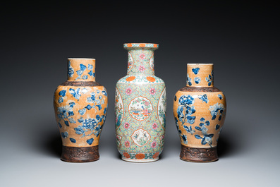 A Chinese Canton famille rose rouleau vase and a pair of Nanking vases, 19th C.