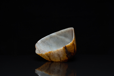 A Chinese hollowed jade libation cup on wooden stand, probably Qing