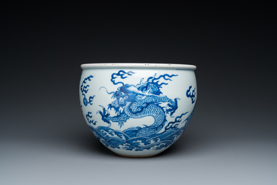 A Chinese blue and white 'dragons and carps' jardini&egrave;re on wooden stand, 19/20th C.