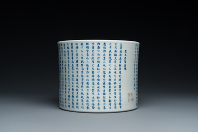 A Chinese blue, white and copper-red inscribed brush pot, Kangxi mark, 19/20th C.