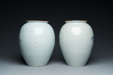 A pair of Dutch Delft blue and white tobacco jars with brass lids, 18th C.