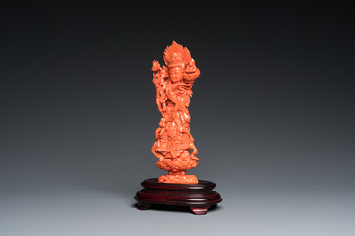 A Chinese red coral carving of Guanyin standing on a lotus throne, 19th C.