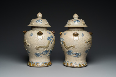 A pair of Vietnamese Bat Trang stoneware 'dragon' vases and covers, 19th C.